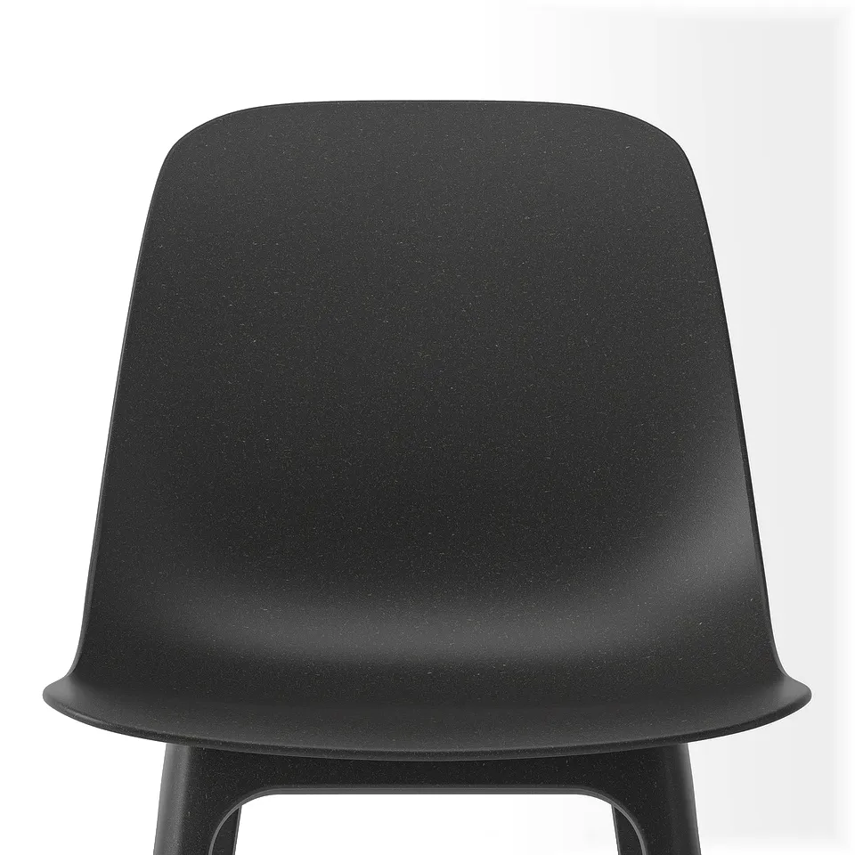 Black plastic chair with curved, seamless seat and back. Simple, sturdy design.
