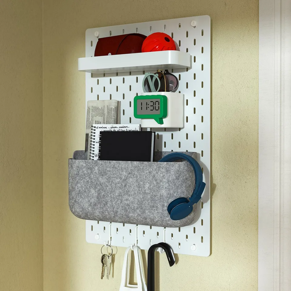 Wall-mounted organiser with clock, headphones, keys, and sunglasses.