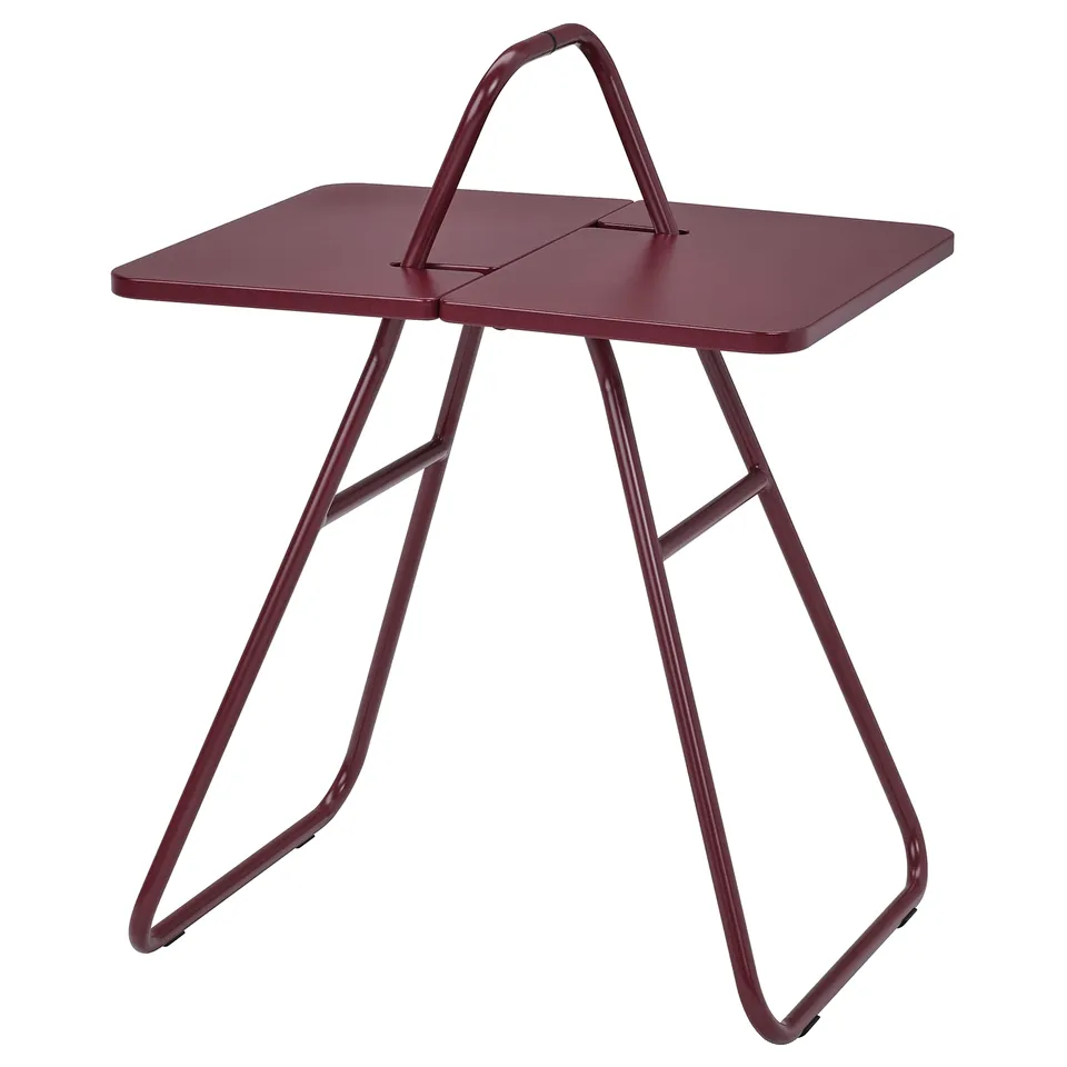 An IKEA PS 2026 red foldable side table with a sturdy metal frame and a carrying handle for easy transport.