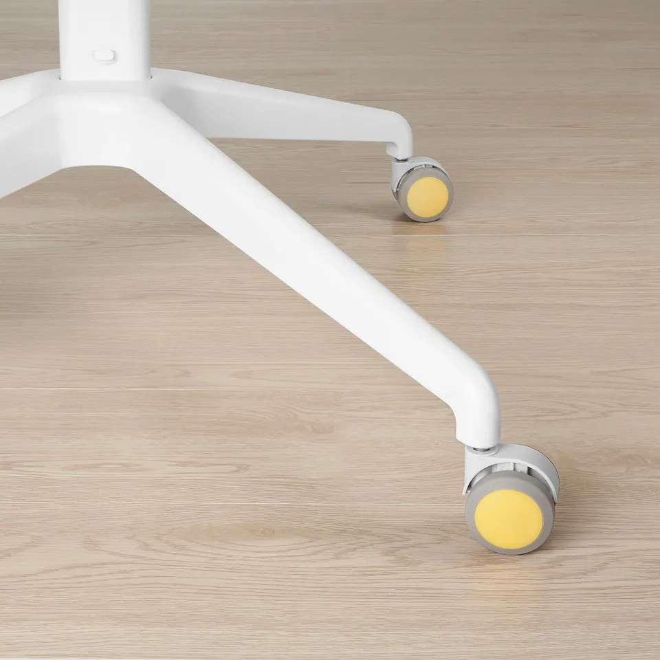 Close-up of a white adjustable chair base with yellow castors on wooden floor.