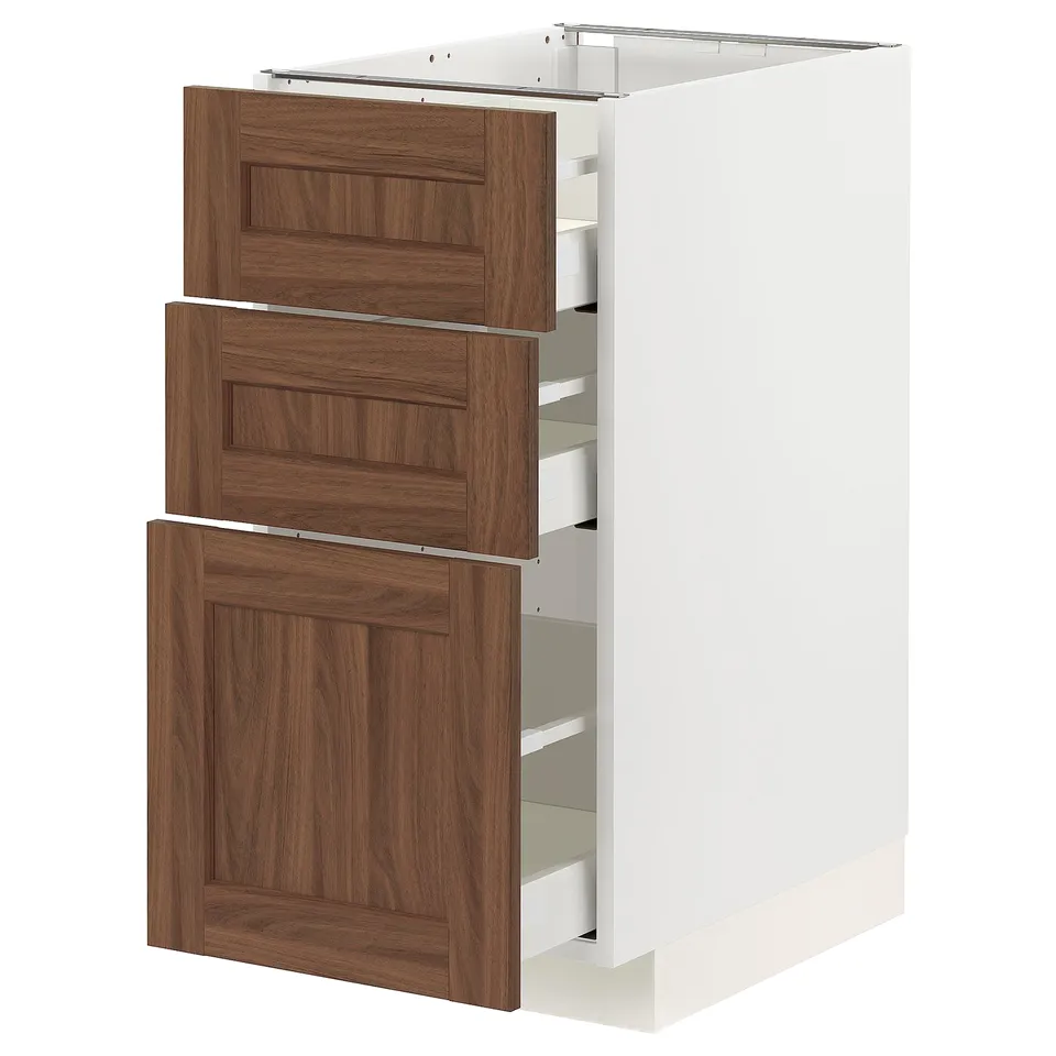 An open METOD kitchen cabinet with walnut-finished drawers. It has three drawers and a push-to-close mechanism.