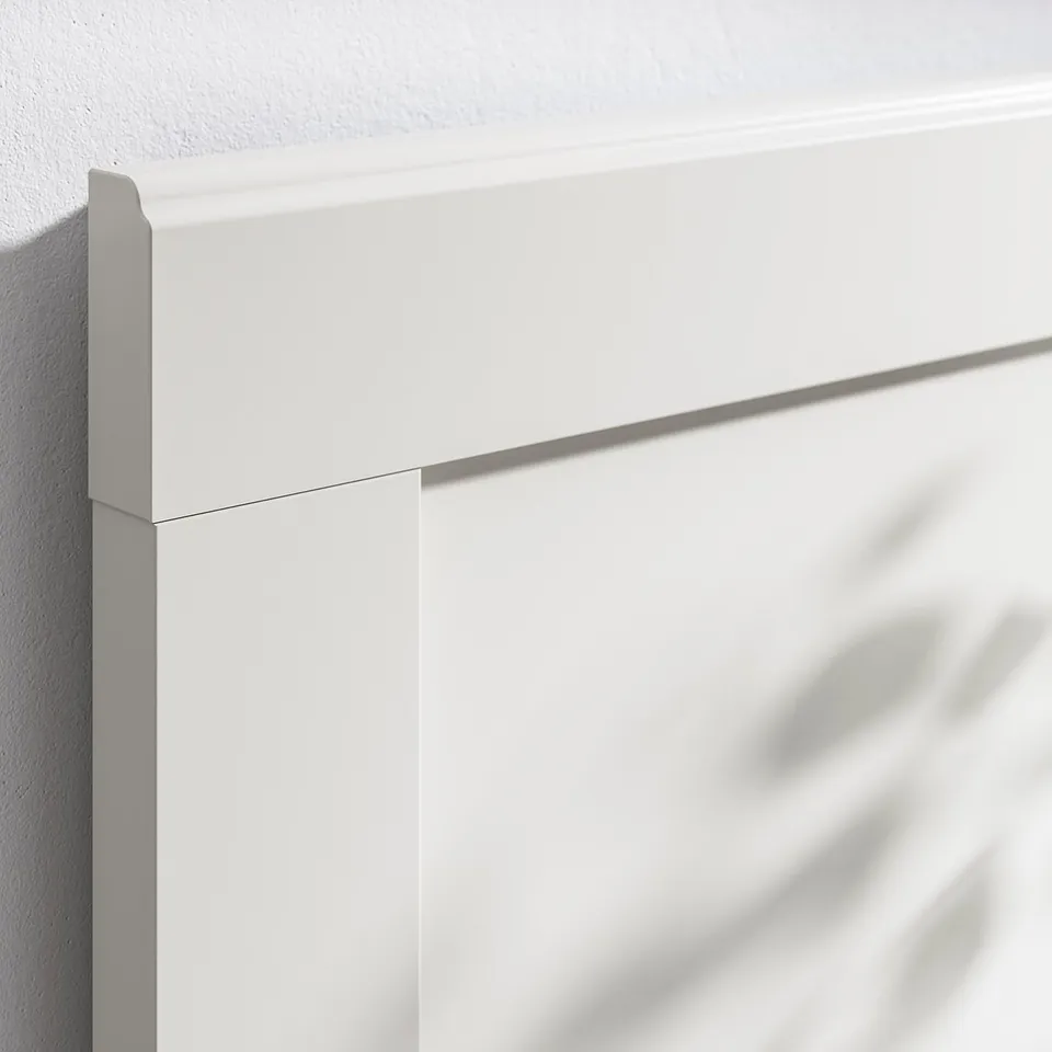Close-up of clean-lined, high-quality white corner of a sturdy bed frame, showcasing smooth edges and robust construction.