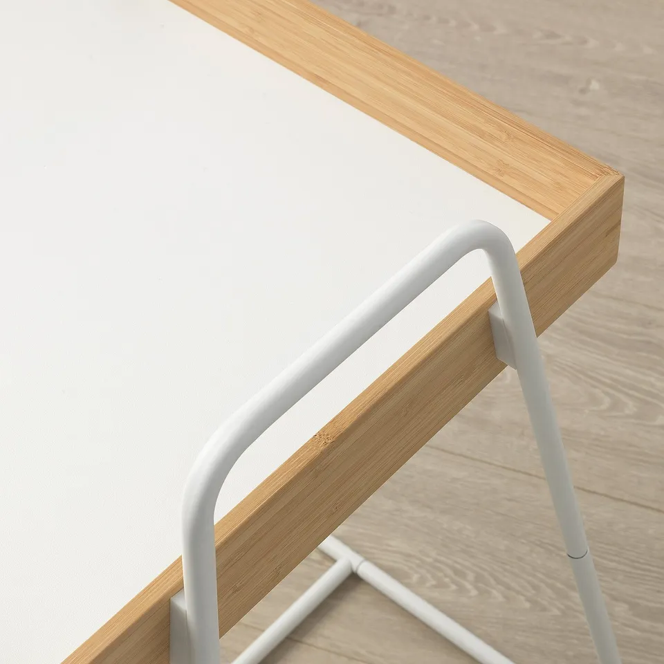 Minimalist side table with light wood top and sleek metal legs. High edges prevent items from sliding off.
