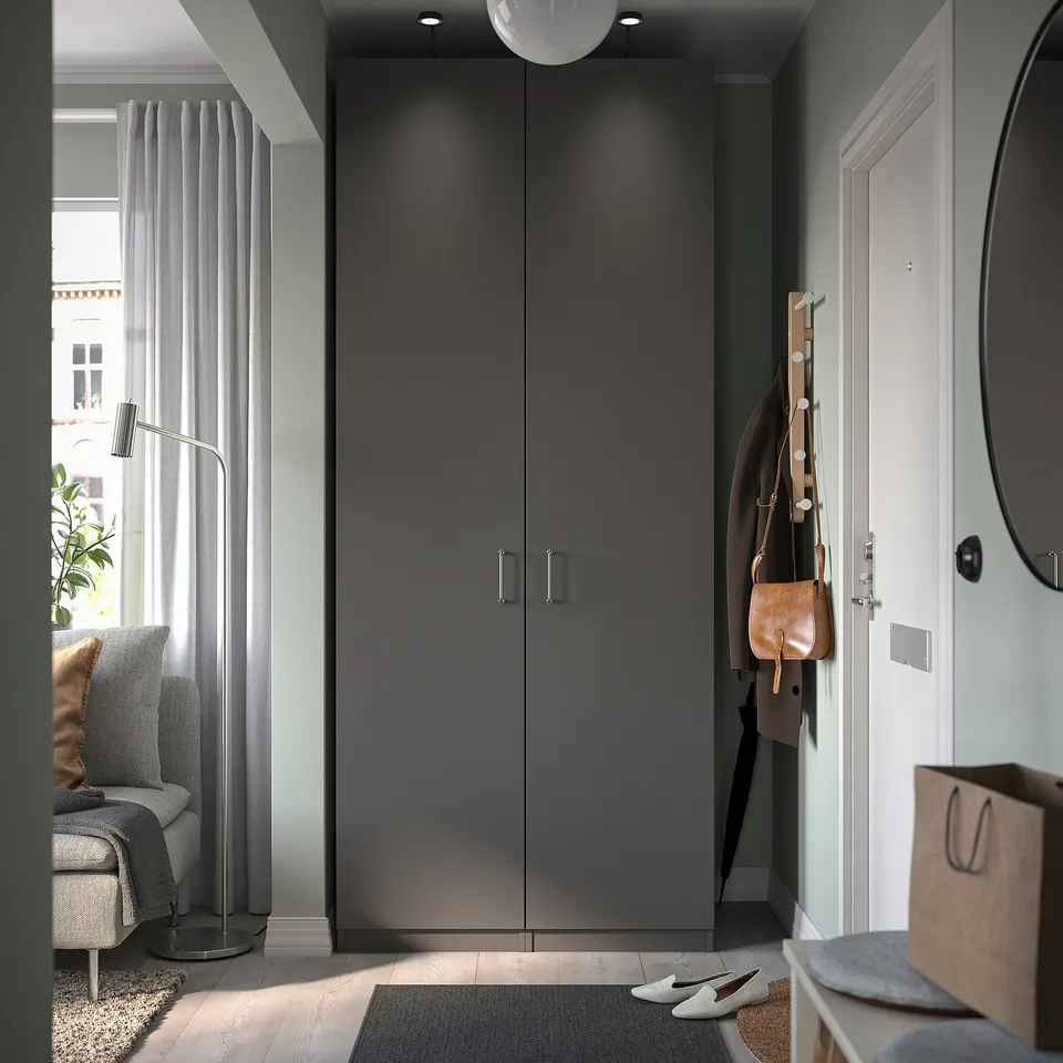 Modern entryway with grey FORSAND door, coat hooks, and beige decor.