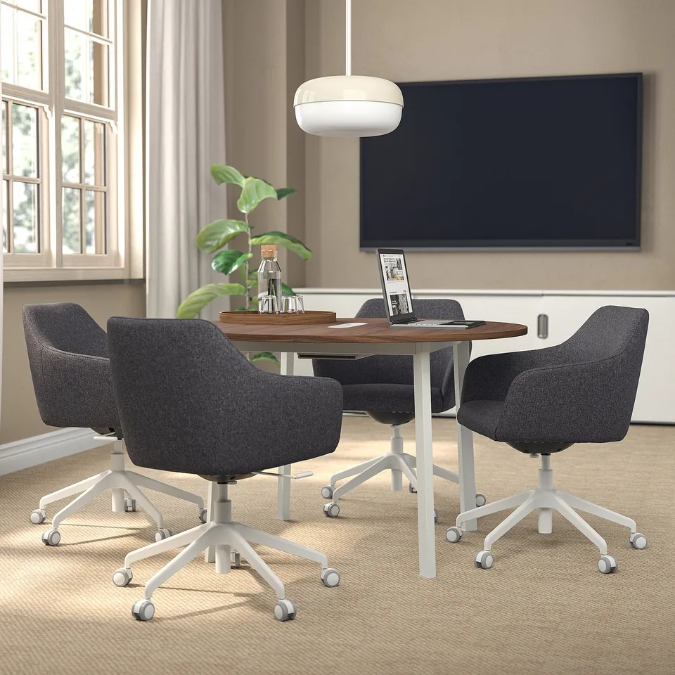 Modern home office with TOSSBERG swivel chair, wooden table, tv, and window.