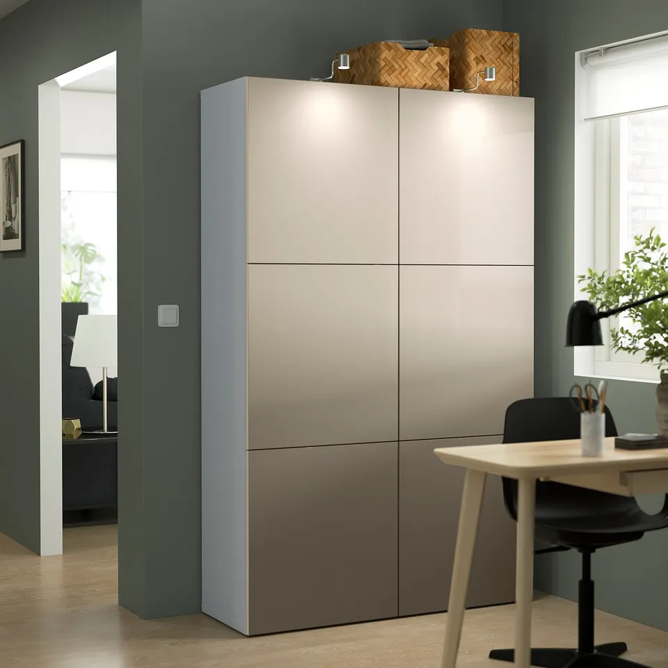 Large BESTÅ cabinet in beige, positioned beside a home office setup, taller than the desk and chair. Topped with a woven basket.