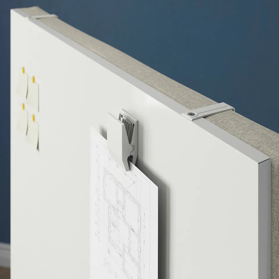 Screen with paper clip detail, showing a whiteboard with architectural blueprint.