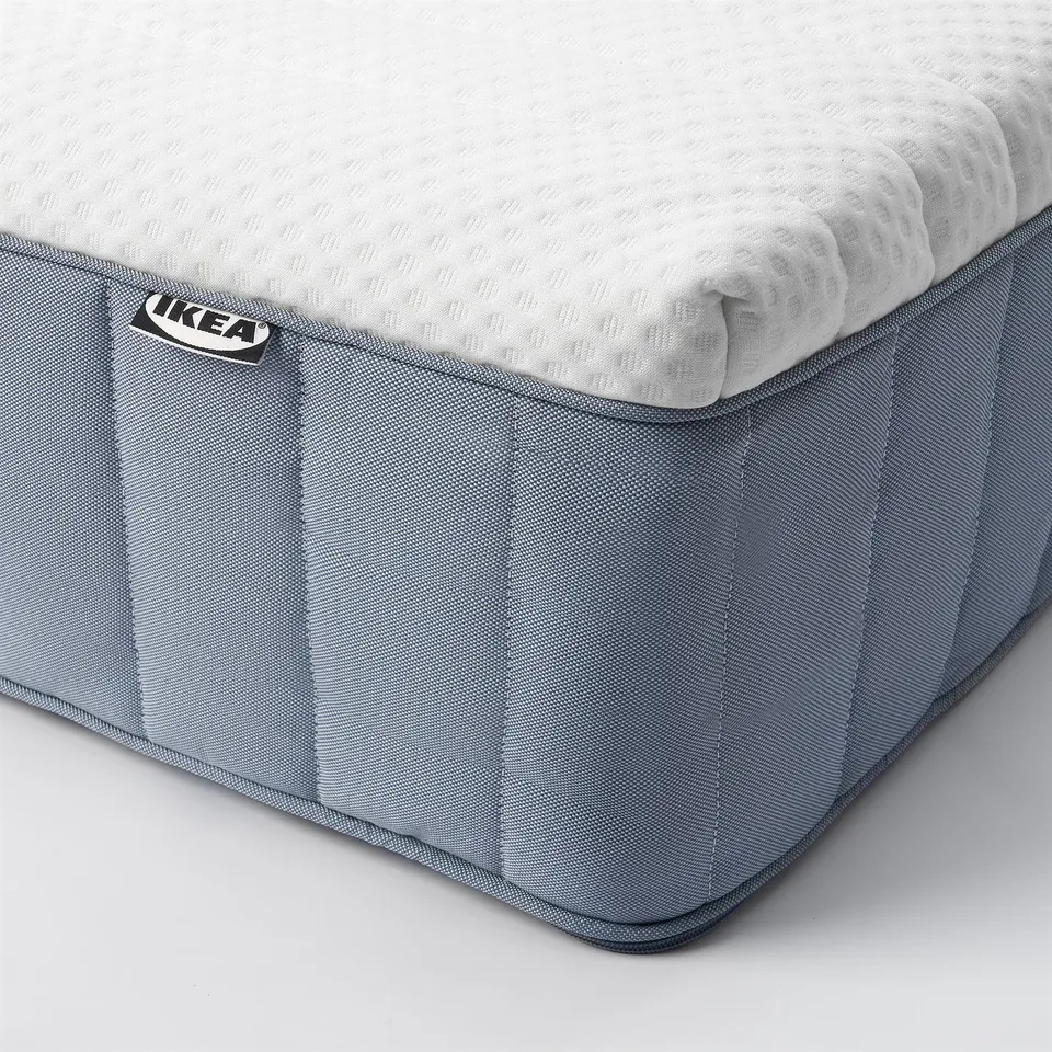 IKEA VITMÅSEN mattress corner shown, with prominent IKEA tag, featuring high-quality fabric and supportive springs.