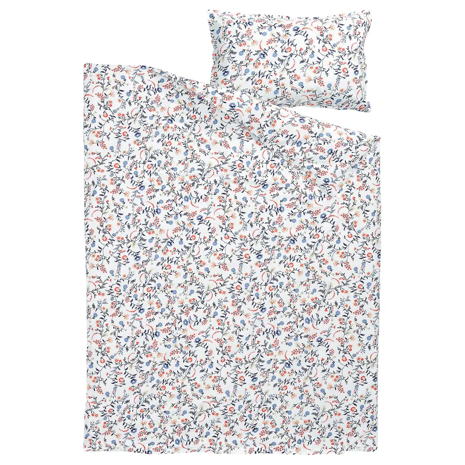 A BRUDKRUSBÄR duvet set in a floral white design with blue and orange patterns, made from 100% organic cotton.
