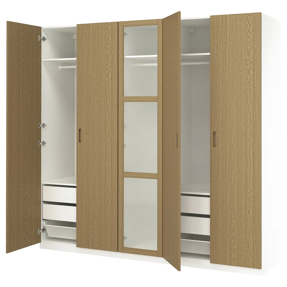 PAX wardrobe - light oak. Two open sections reveal shelves, drawers, and hanging space. Sleek, modern design with soft-closing hinges.