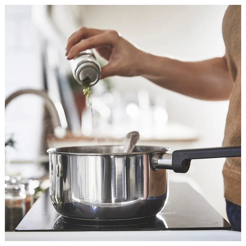 Seasoning saucepan on stove