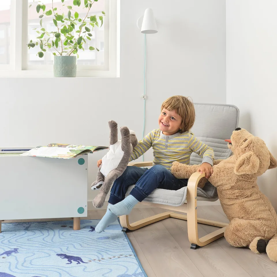 Child in mini armchair with teddy. Comfortable, matches adult POÄNG.