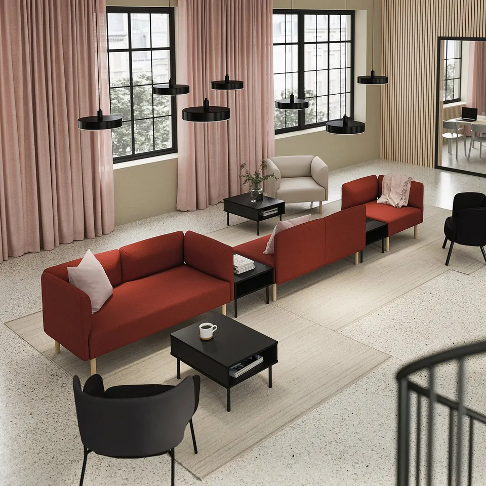 Modern living room with red LILLEHEM modular sofa, black chairs, coffee tables, pink curtains, large windows, black pendant lights.