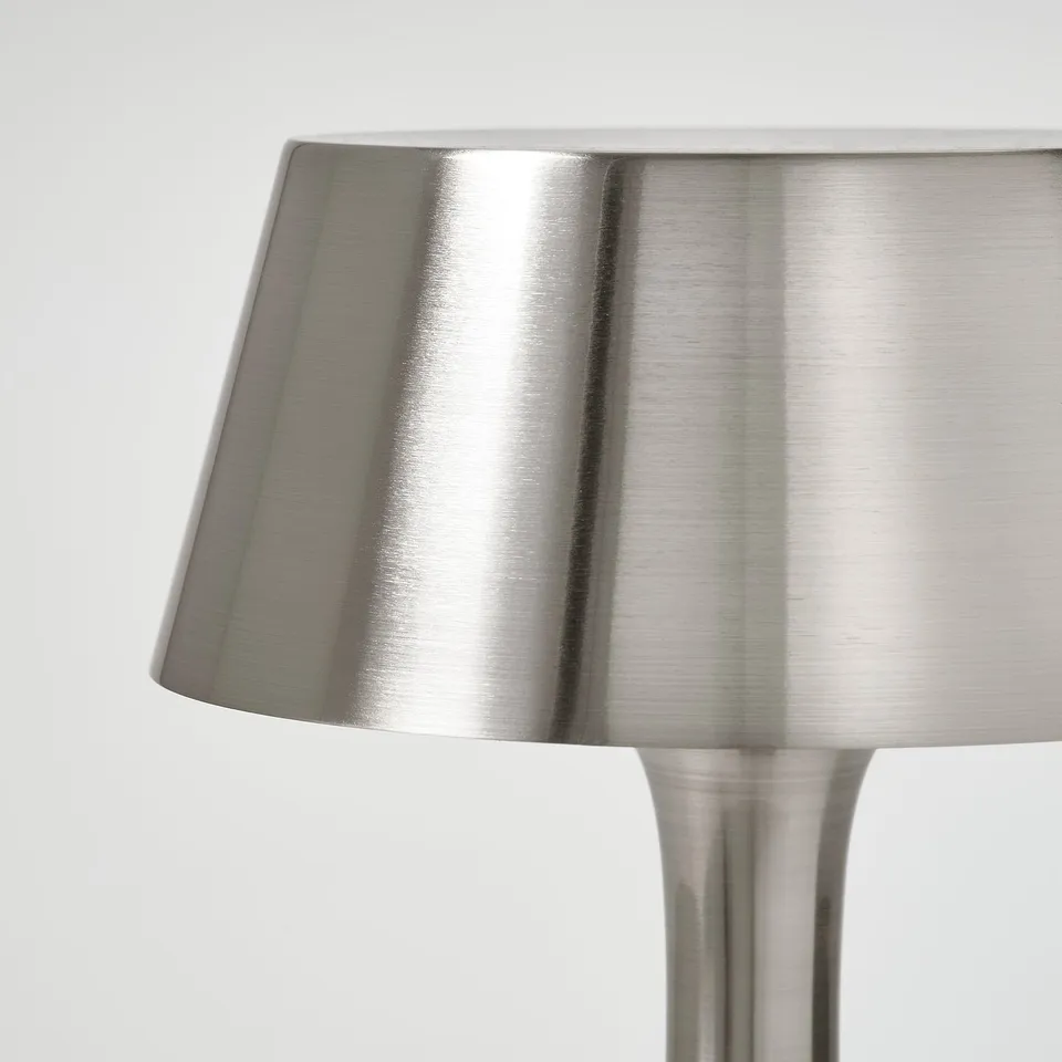 Modern sleek metal lamp, brushed nickel finish, stands upright.