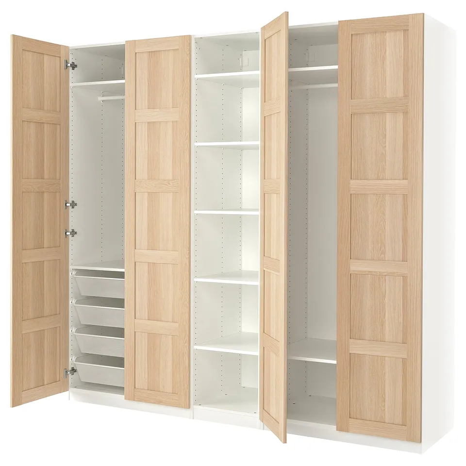 Open wooden PAX wardrobe. Crafted from oak with white interior, showing multiple shelves and drawers.