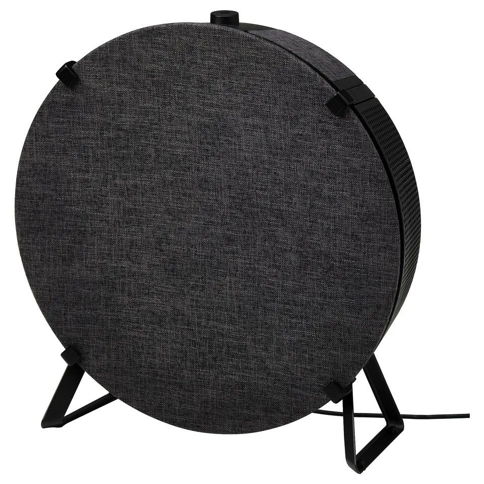 Black circular fabric air purifier on a three-legged stand.