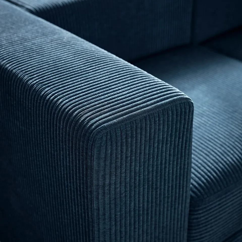A plush, textured blue sofa with a ribbed pattern, offering a soft and inviting seating experience.