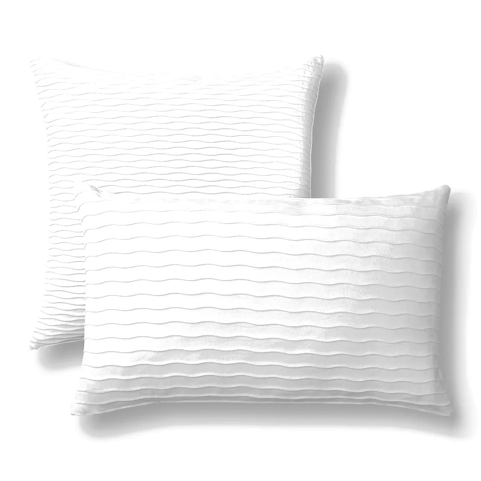 Two white VÄNDEROT pillows with cotton velvet covers and duck feather filling, one upright, one leaning. Different designs on each side.