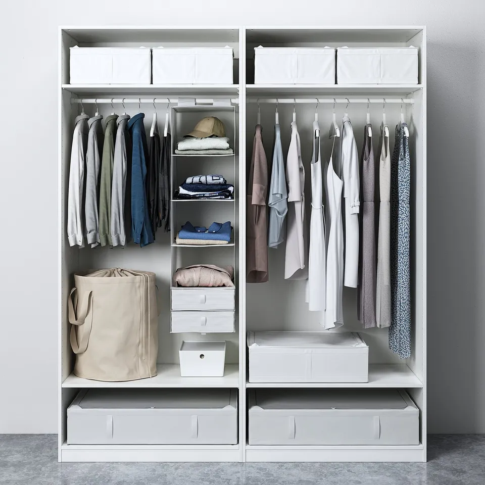 Open wardrobe with shirts, bags, bins. Shelves and drawers for clothes and accessories.