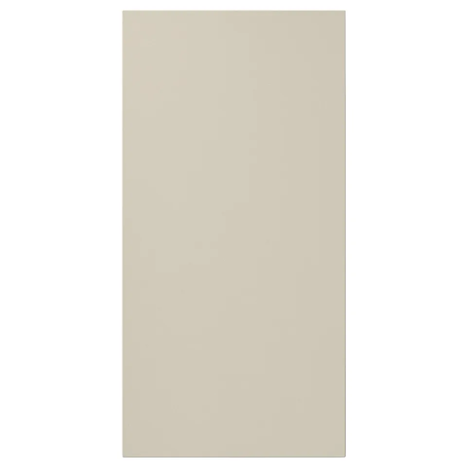 A beige HAVSTORP cabinet door, rectangular with smooth, clean lines and a neutral modern style, made from acrylic paint and fiberboard.