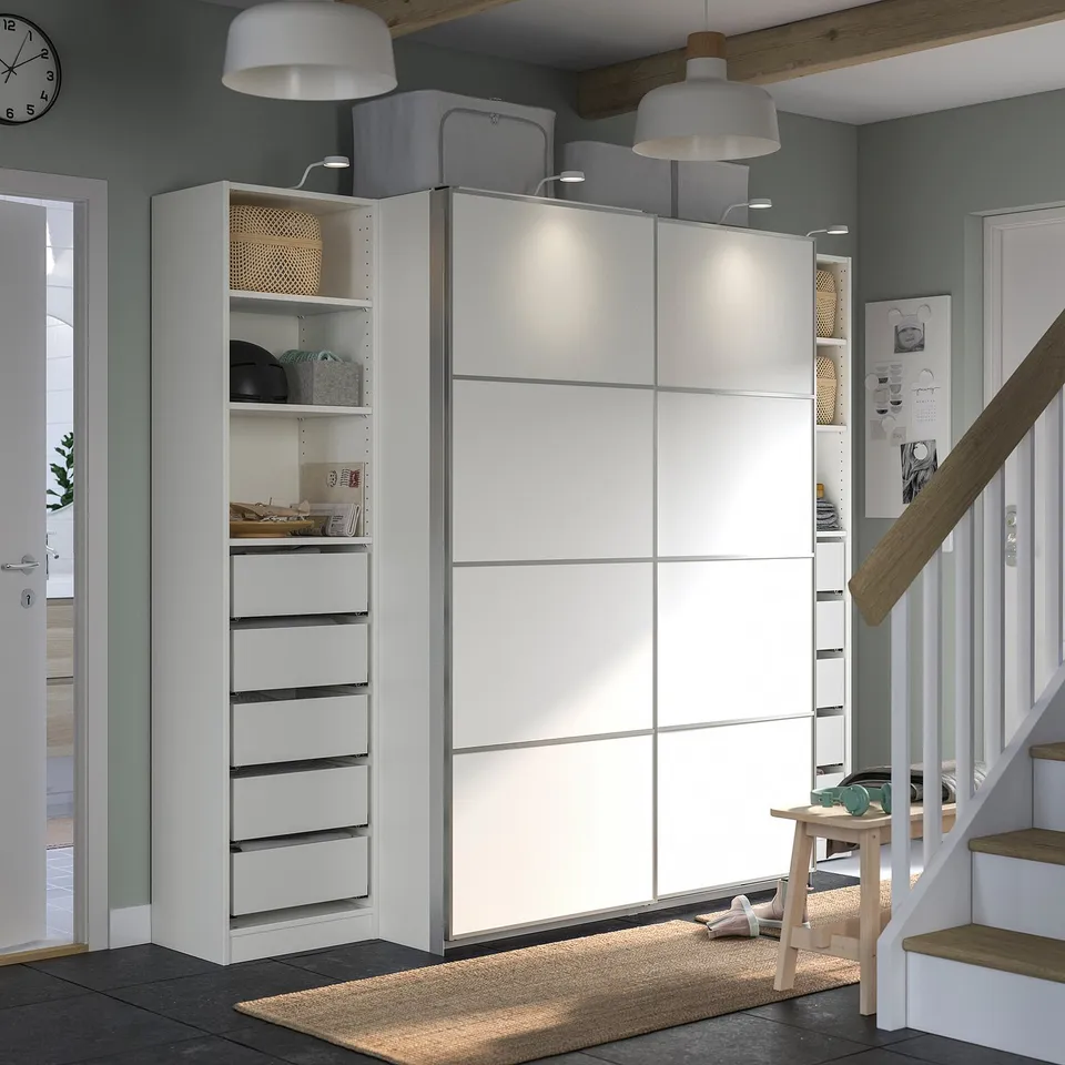 Modern entryway with PAX wardrobe, white, sliding doors, sleek design.