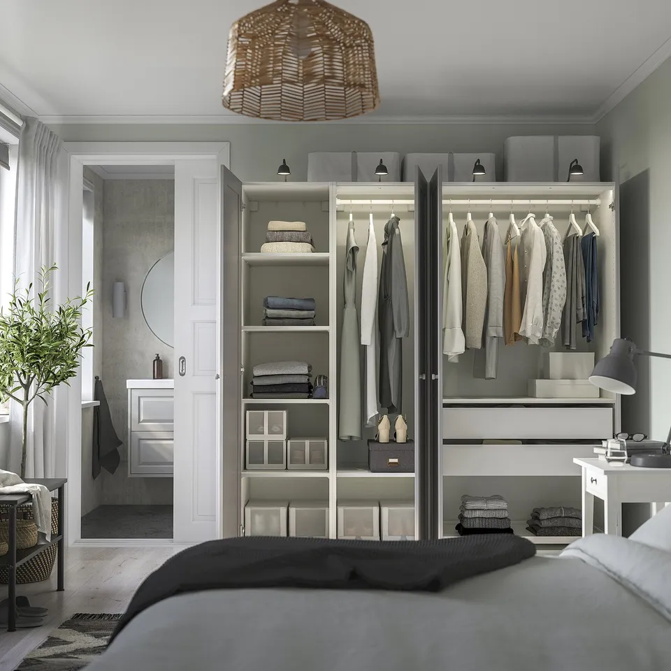 Modern bedroom with IKEA PAX wardrobe, shelves, hangers, boxes, and integrated lighting.
