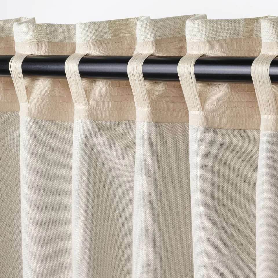Curtains with looped rod pockets, designed for easy hanging, blocking light and adding stylish decor.