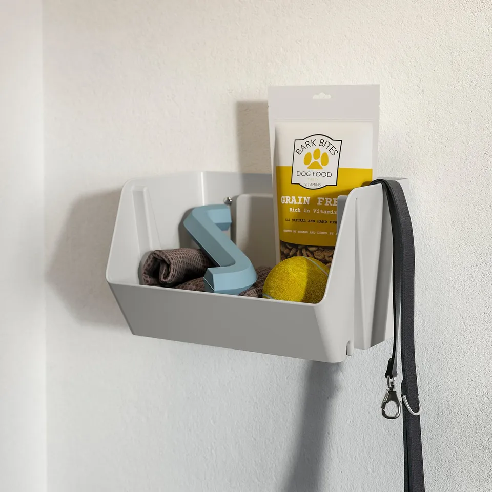 Wall-mounted pet organiser with dog treats, leash, and toys.