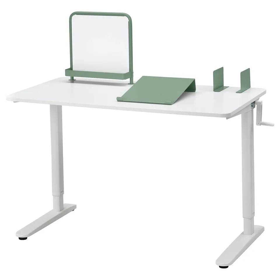 White height-adjustable desk with green accents, magnetic board, writing pad, bookends, and crank handle.