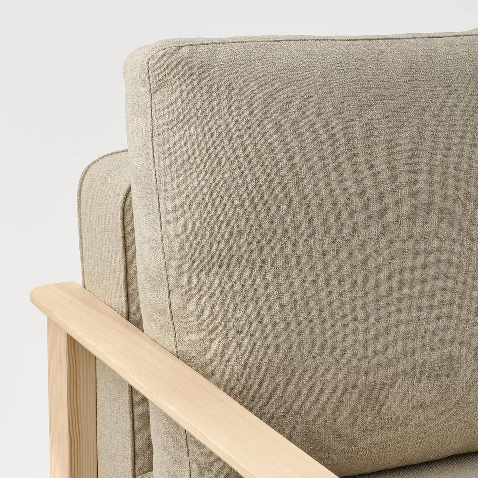 Grey armchair with wooden armrests. Visible stitching and upholstery detail. Modern, minimalist design.