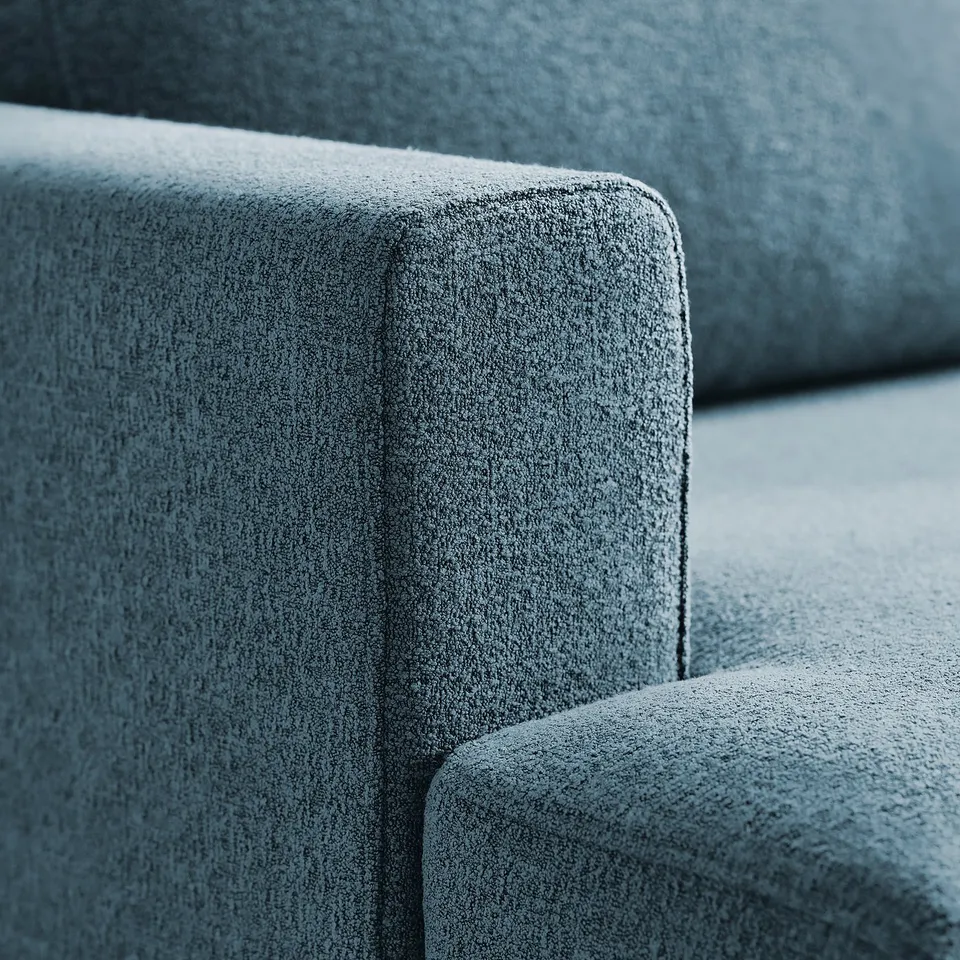 Close-up of a grey fabric sofa, showcasing its soft, high-quality, textured material and clean, modern design.