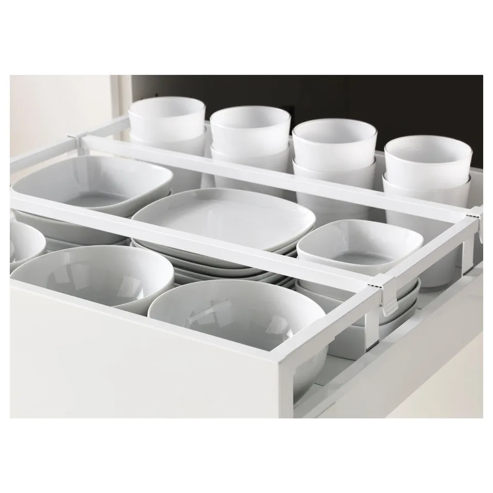 Organised white crockery in kitchen drawer, showcasing neat arrangement and easy access.