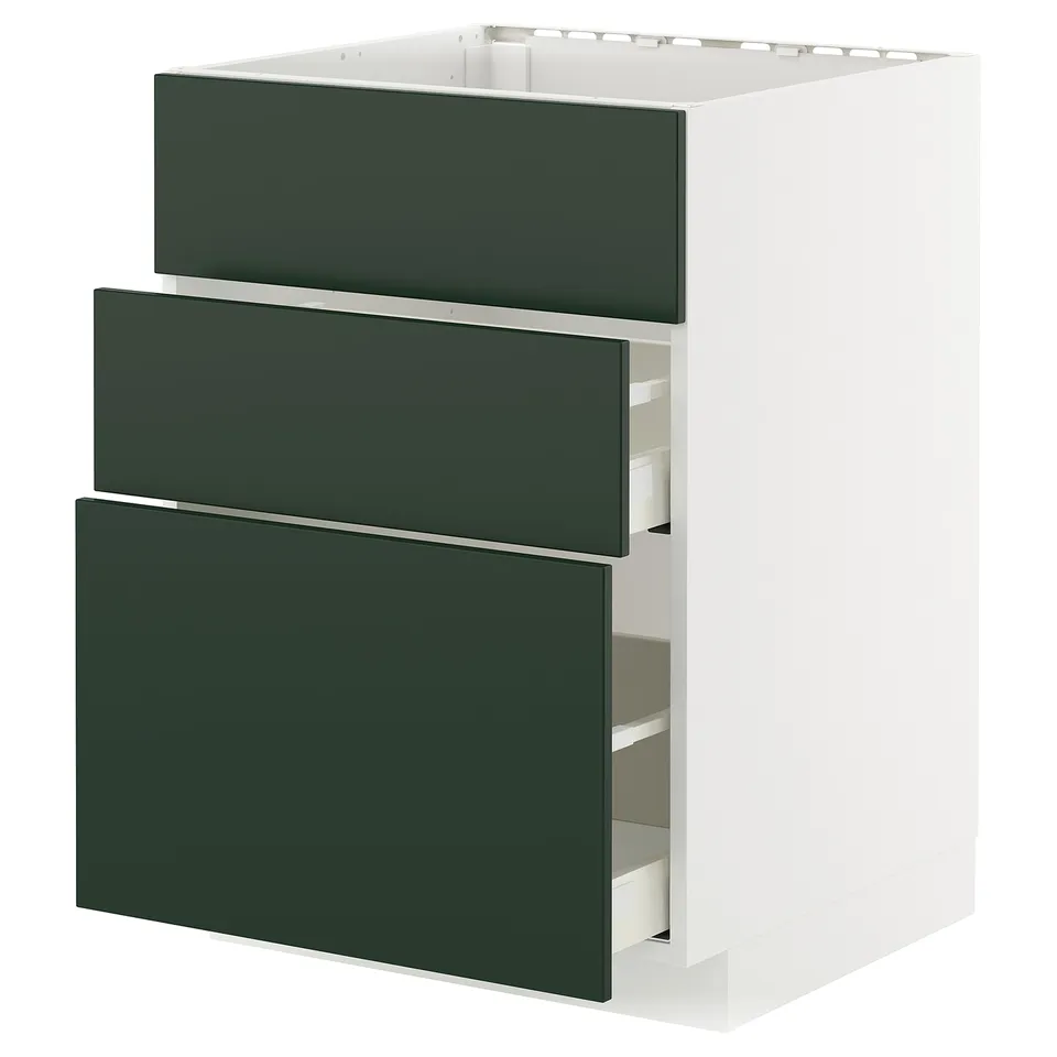 A white METOD kitchen cabinet with three dark green drawers. The drawers are partially open, revealing their interiors.