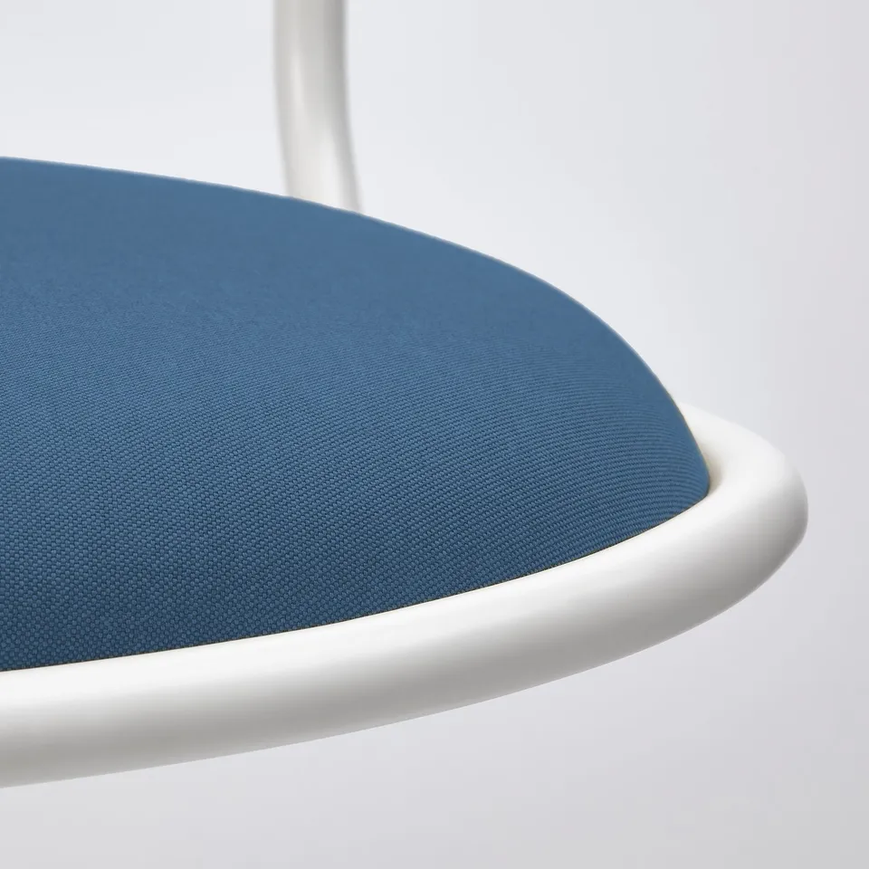 Close-up of modern office chairs blue seat, showing high-density foam and quality materials.