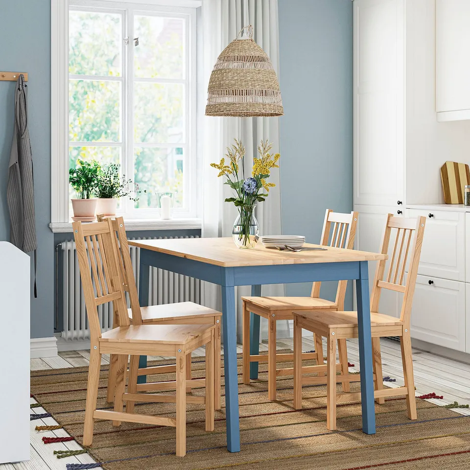 Small blue and natural wood dining set with 4 chairs, table, and flowers.
