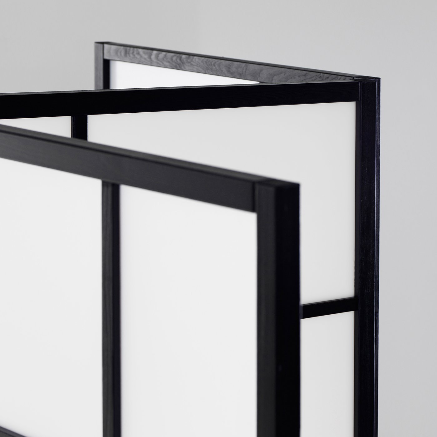 Black wooden room divider, folded neatly. Strong, sleek design with visible wood grain.