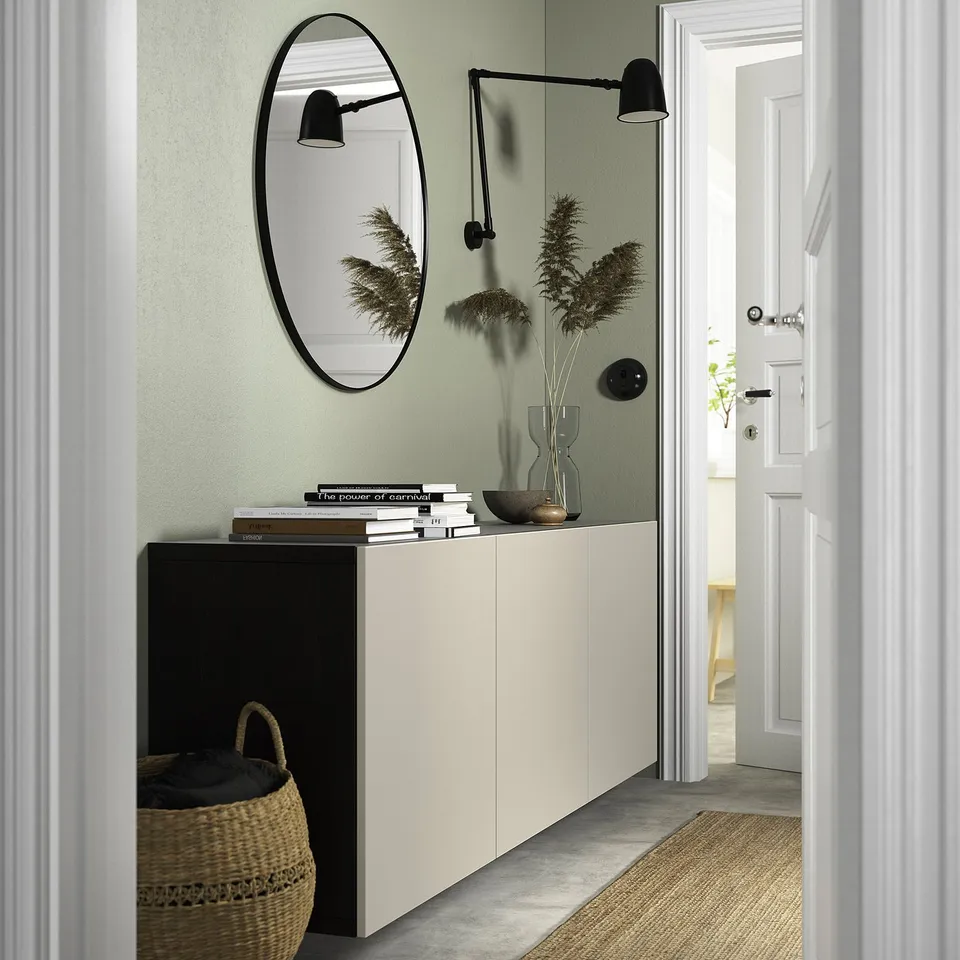 Modern entryway with BESTÅ sideboard, mirror, & decor.
