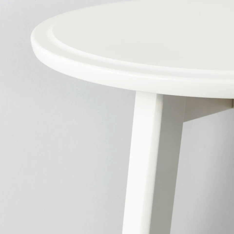 A modern, round coffee table with smooth edges and a white finish. The table has a sturdy, minimalist design and visible legs.