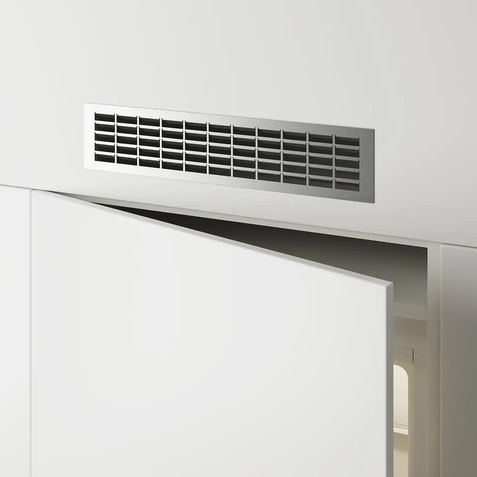 White wall vent above door for air circulation.