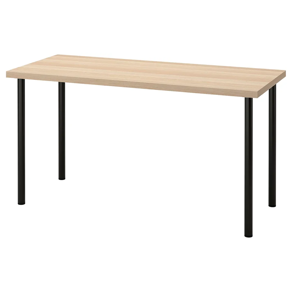 LAGKAPTEN desk in light oak and black, rectangular top with four round legs, minimalist design.