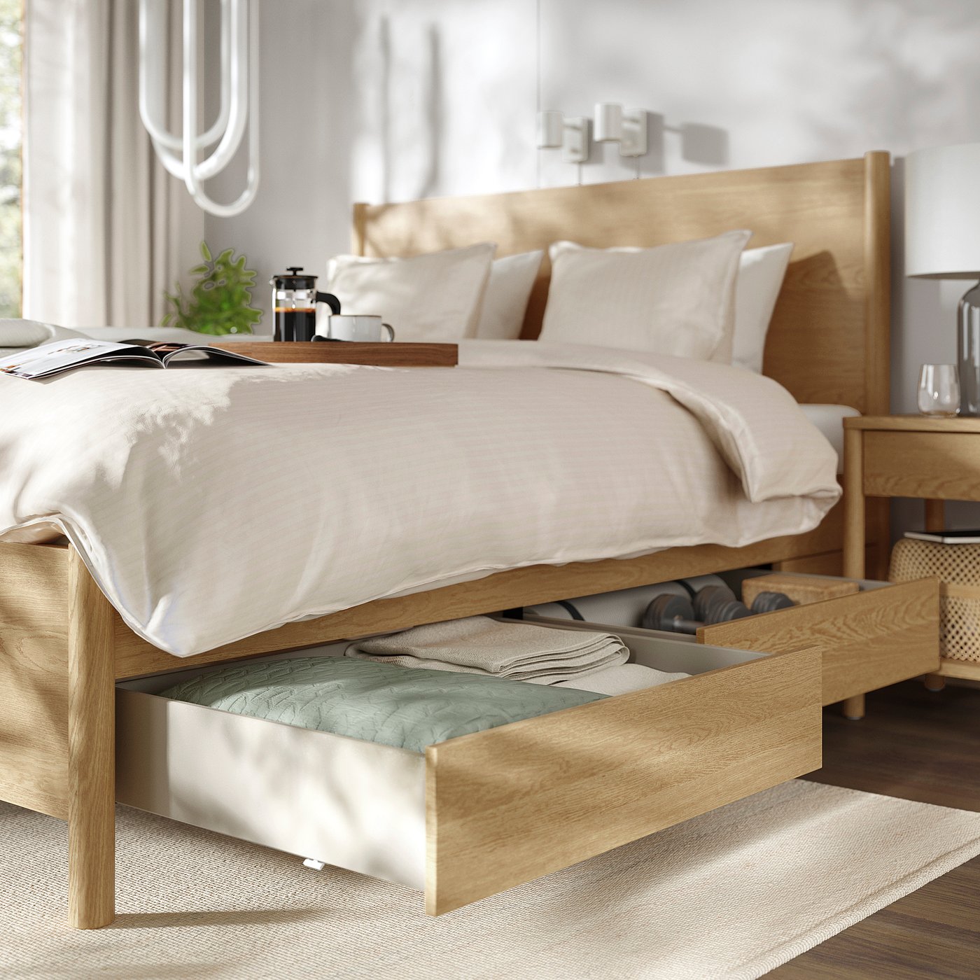 Modern wooden bedroom set with under-bed storage drawers, one open showing items, light-colored bedding, and bedside table with glass carafe.
