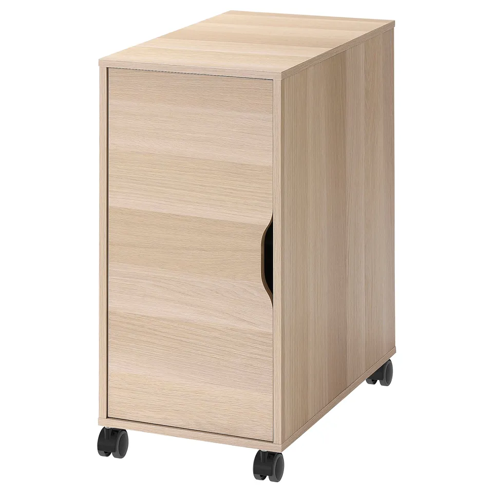 A light brown wooden ALEX storage unit with wheels. The cabinet a single door with a handle and castor wheels for mobility.