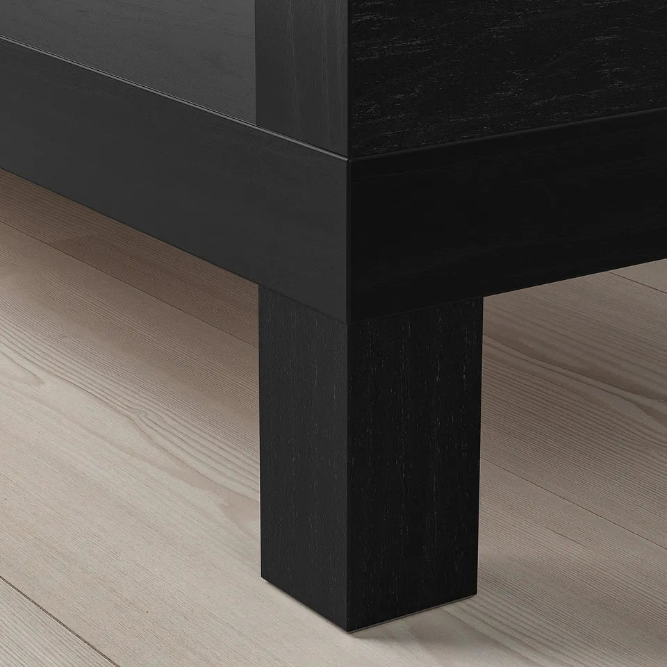 BLACK wooden furniture piece with clean, modern lines on a light wooden floor.