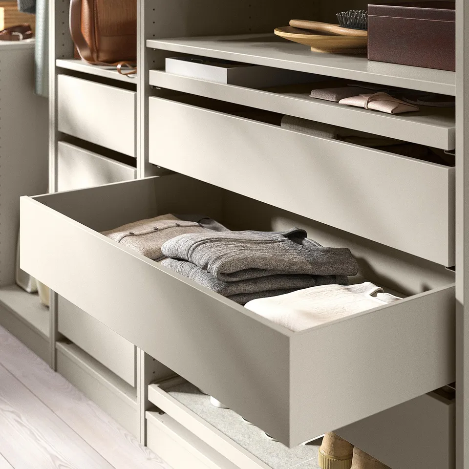 A grey KOMPLEMENT drawer, popular for organising folded clothes. Its part of a storage unit, illustrating a tidy, minimalist look.