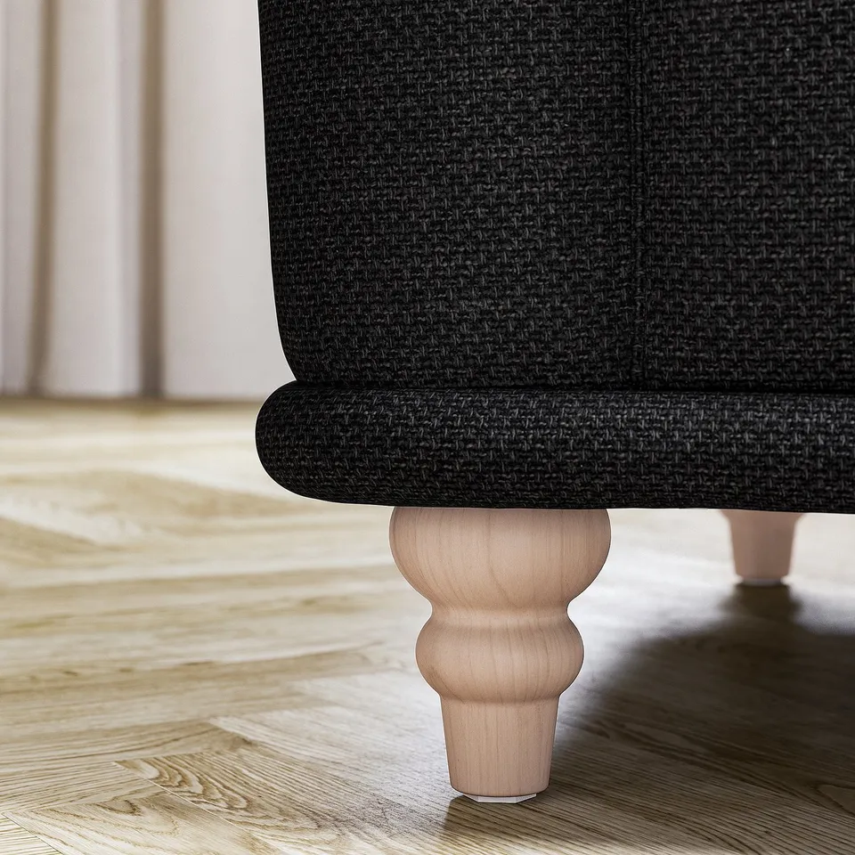 Black upholstered VISKAFORS sofa with wooden leg.