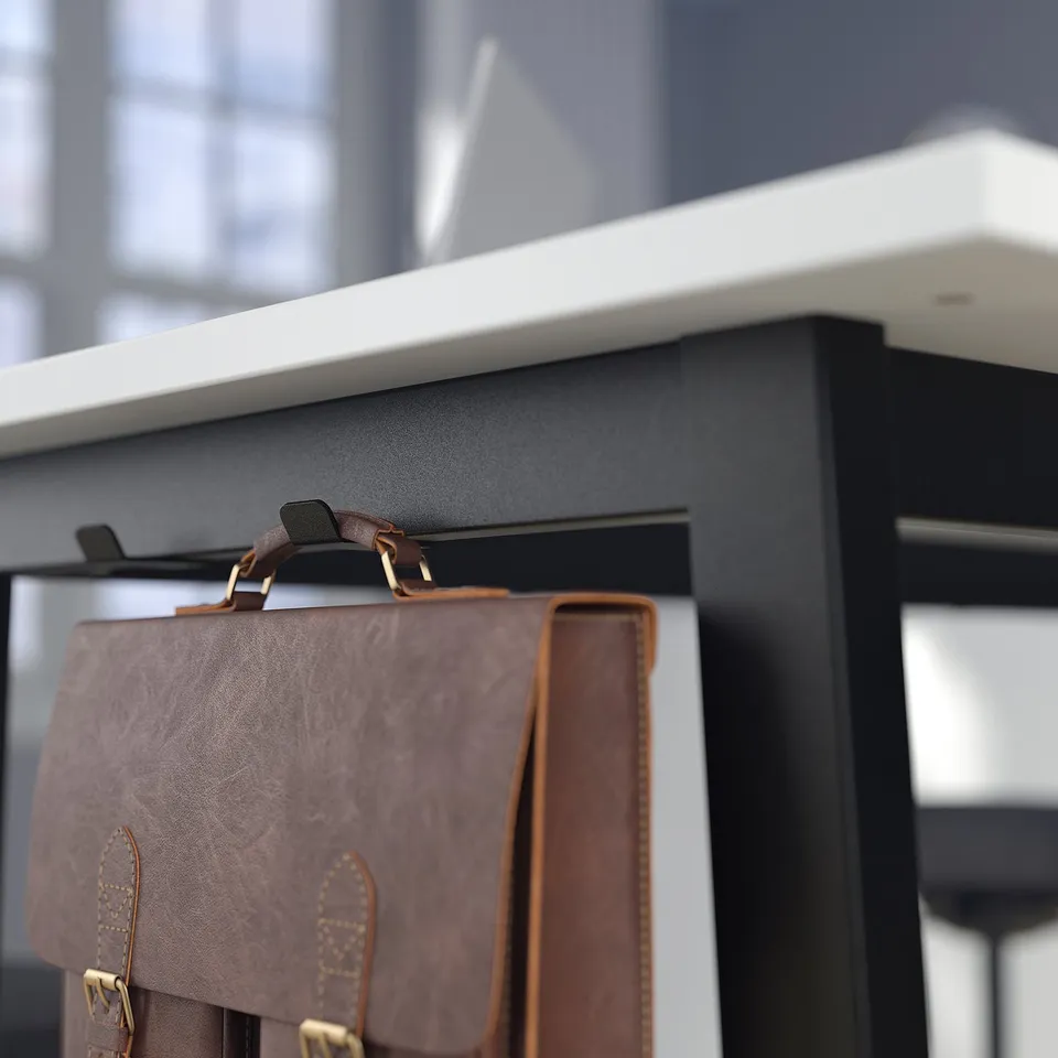 Brown leather bag hangs securely on hook of high tables built-in hanger.