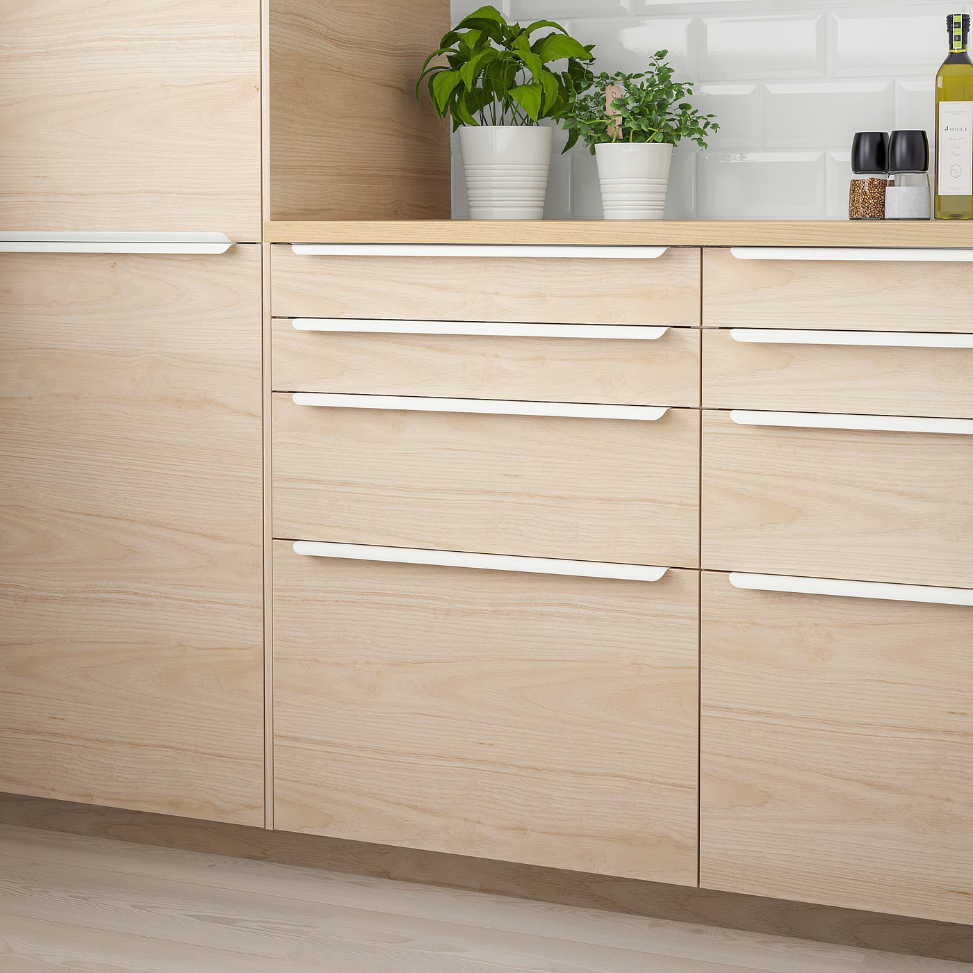 ASKERSUND light ash wood drawers; modern design with sleek handles; fits perfectly in kitchen space.