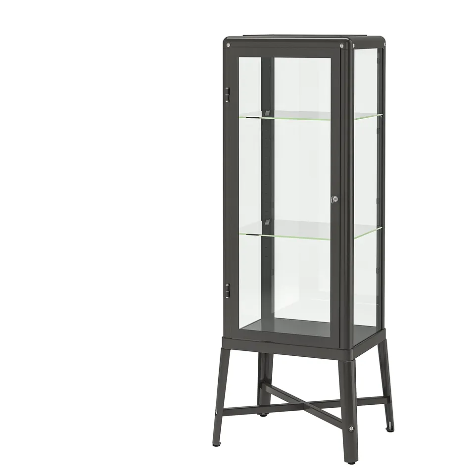 A black FABRIKÖR glass-door cabinet with metal frame and adjustable shelves, suitable for displaying collectibles or storing items.