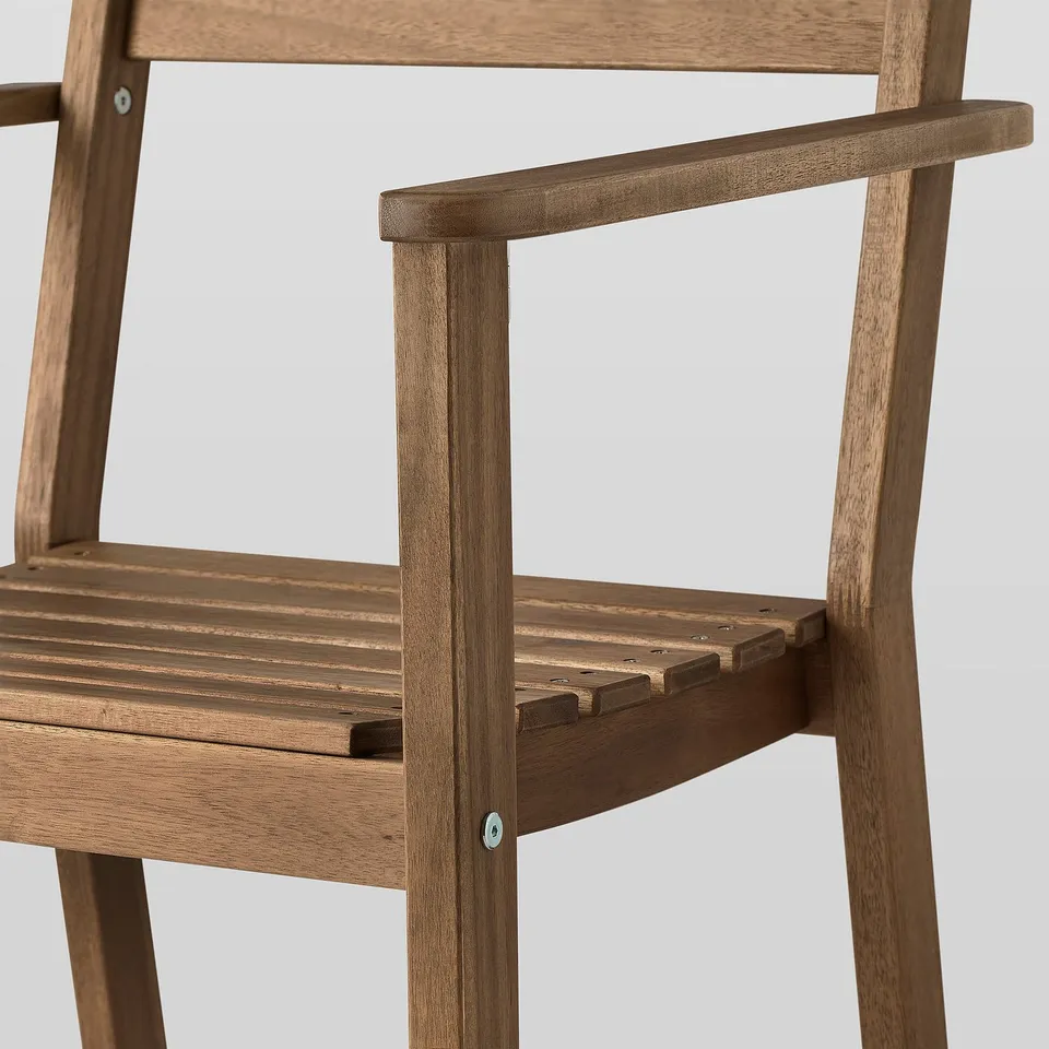 Close-up of a wooden chairs armrest and seat. Shows quality craftsmanship with smooth finish and sturdy joints.