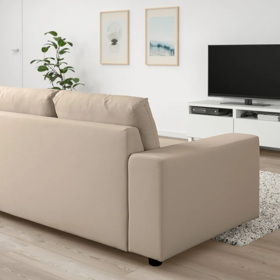 Modern living room with beige VIMLE sofa. Neutral decor, tv, plant.